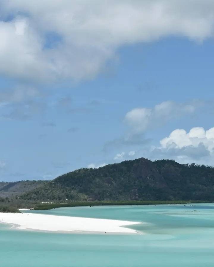 Hill Inlet from the lookout: white sand and shallow turquoise water below green hills